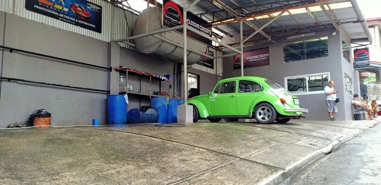 Lime green Volkswagen Beetle parked at the shop