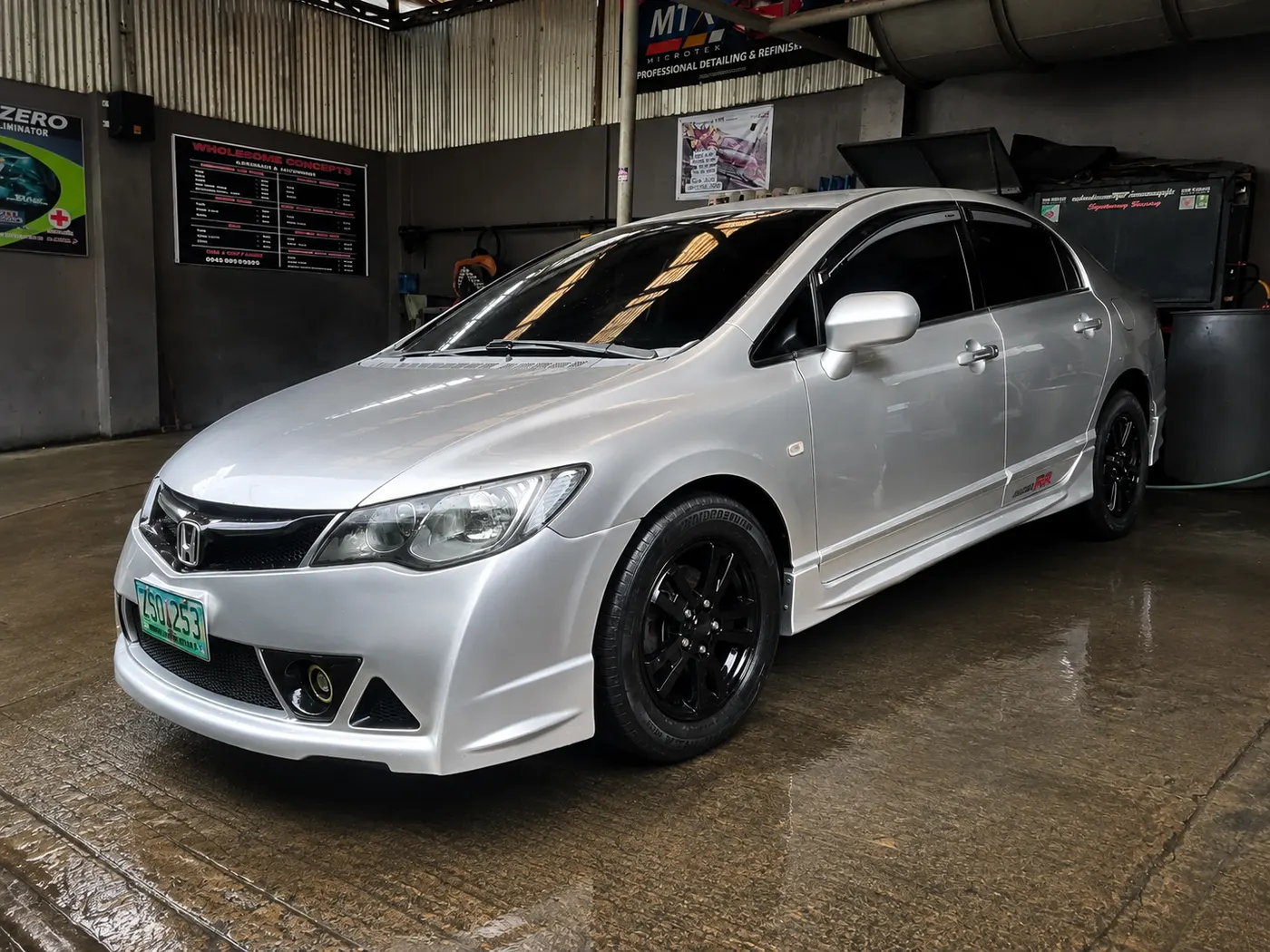 Silver Honda Civic sedan with black wheels