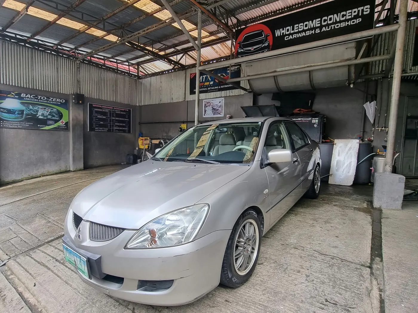 Silver Mitsubishi Lancer sedan in the Wholesome Concepts bay