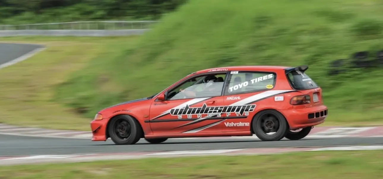 The Wholesome Concepts Honda Civic at speed on a race circuit